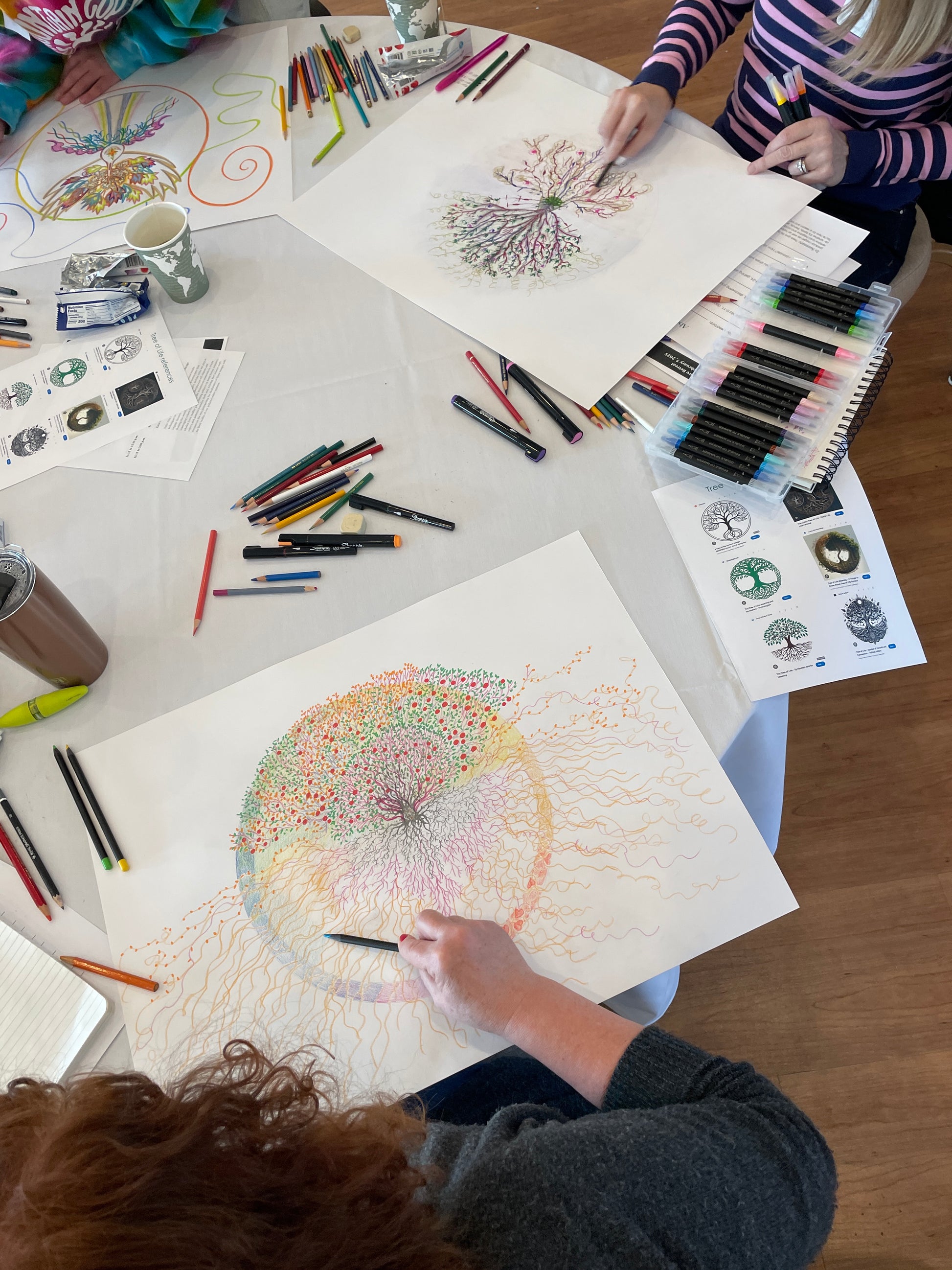 Students at a table unleashing their creativity by making personal trees of life